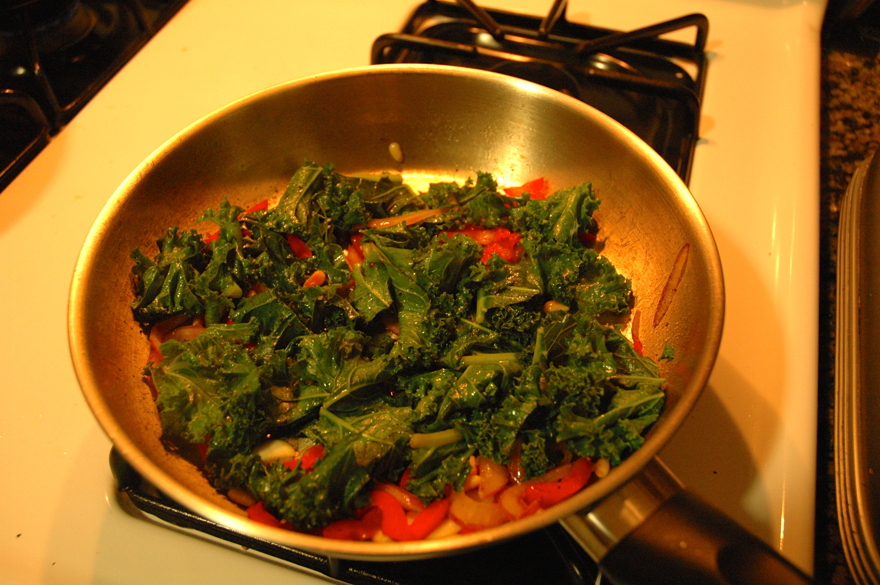 Sautéed Kale with red pepper, onion, black olive and pine nuts by Tracy Lee Karner