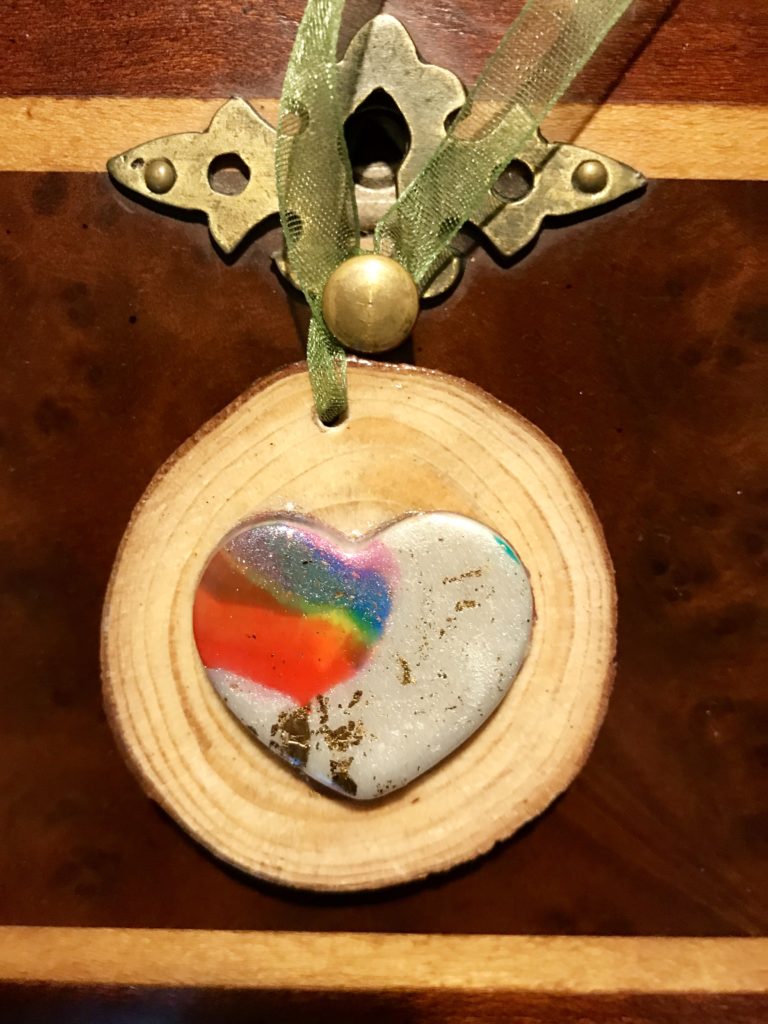 multi-colored heart on round wood block